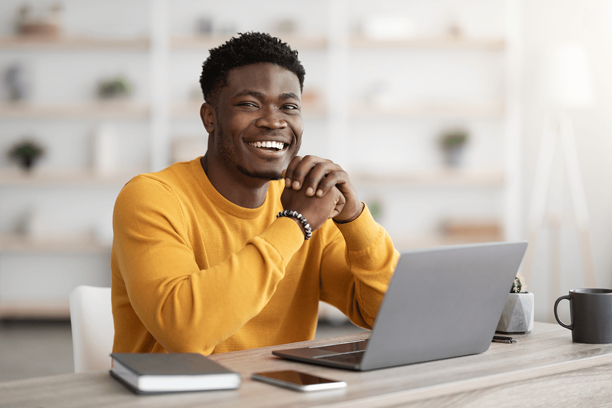 black-man-freelancer-sitting-at-workdesk-at-home-2022-12-16-08-26-37-utc